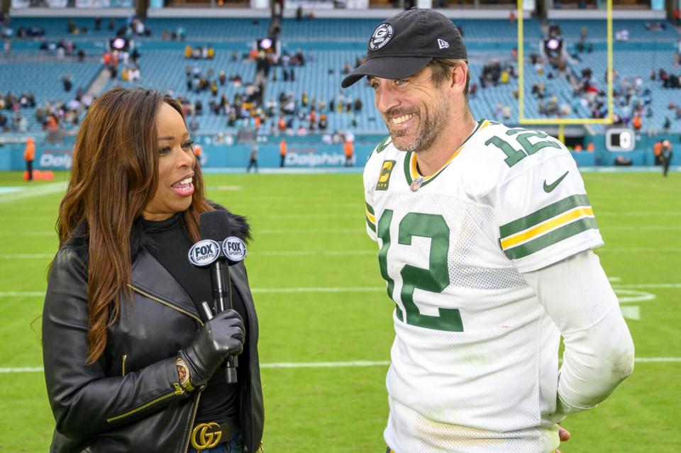 Fox Sports sideline reporter Pam Oliver interviews Packers quarterback Aaron Rodgers on the field