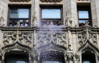 Fans cheer as members of the World Cup-winning US women's soccer team take part in a ticker tape parade for the women's World Cup champions on July 10, 2019 in New York. - Amid chants of "equal pay," "USA" and streams of confetti, the World Cup-winning US women's soccer team was feted by tens of thousands of adoring fans with a ticker-tape parade in New York on Wednesday. (Photo by Johannes Eisele/AFP/Getty Images)