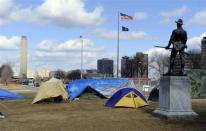 A statue honoring soldiers from the Spanish American War stands guard over an Occupy Wall Street encampment as the Liberty Memorial Tower soars above the National World War One Museum in Kansas City Missouri February 24, 2012.