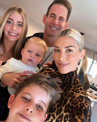 <p>Tarek El Moussa/ Instagram</p> Heather Rae and Tarek El Moussa take a photo with their blended family