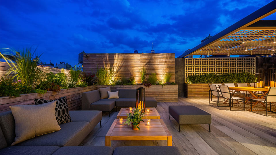Out of the rooftop terrace with lounge seating and custom wooden planters.