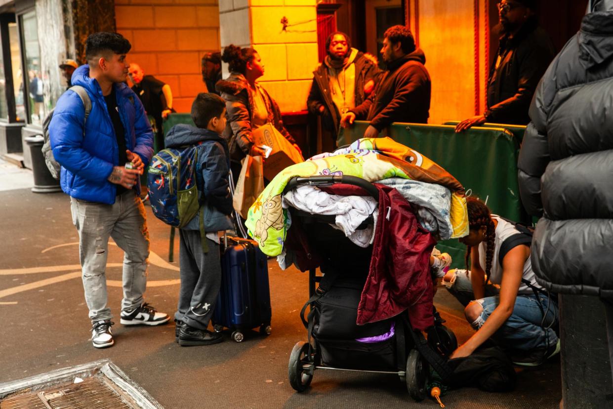 <span>Jhoann Reyes, left, and his family report to the arrival center to request a new shelter placement in New York, on 25 January 2024.</span><span>Photograph: Olga Loginova/The Guardian</span>