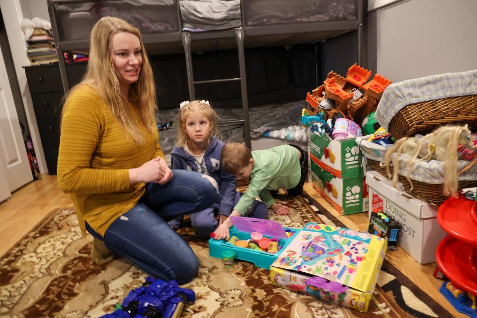 Ukrainian refugee Natalia Voianuik, 32 plays with her children in the family’s apartment in Chicago.