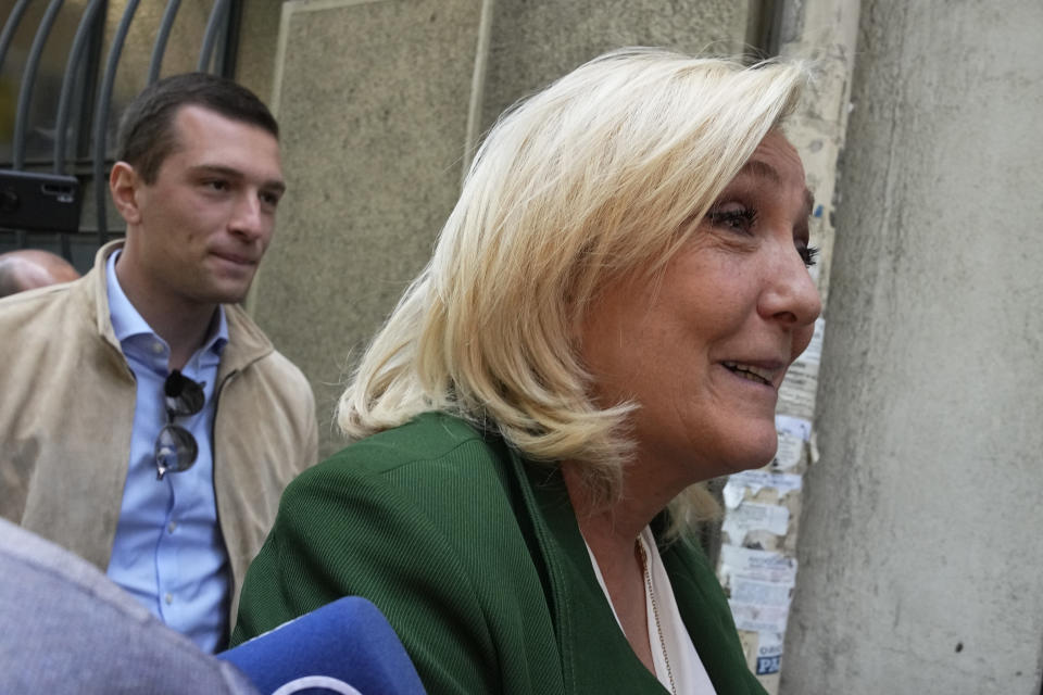 French far-right leader Marine Le Pen, followed by acting National Rally president Jordan Bardella, arrive at their campaign headquarters, Monday, April 25, 2022 in Paris. Far-right leader Marine Le Pen gathered her party's troops on Monday, not to mourn her loss a day earlier in the presidential election but to plot how to scratch out a victory in next month's legislative elections. (AP Photo/Michel Euler)