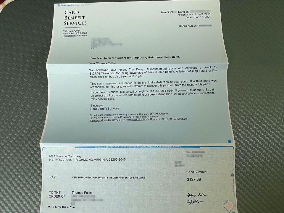 Receiving a mailed check from a travel insurance company.