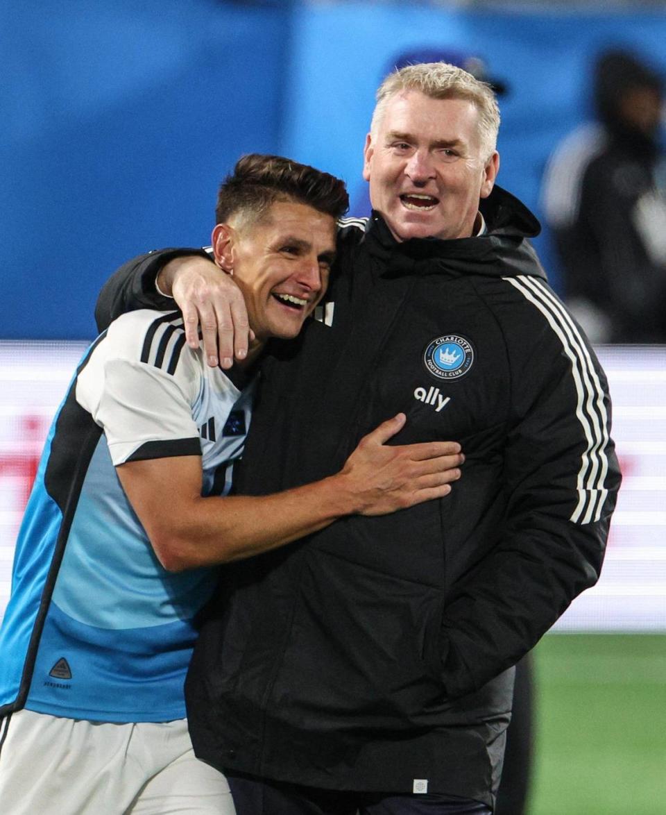 Charlotte FC’s Ashley Westwood, left, shares in a celebratory hug with head coach Dean Smith after a victory against New York City FC, 1-0, during the home opener at Bank of America Stadium in Charlotte, NC on February 24, 2024.