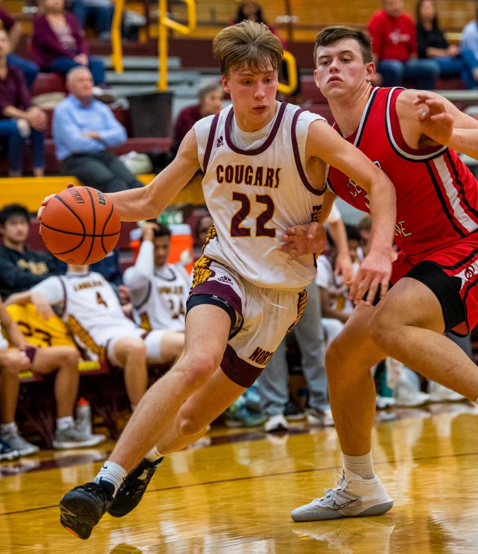 Bloomington North's Luke Lindeman (22) drives past Center Grove's Will Spellman (42) during the Bloomington North versus Center Grove boys basketball game at Bloomington High School North on Friday, Dec. 2, 2022.