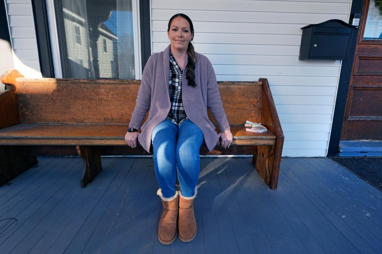 Kristina Amyot sits on the porch of a sober-living home, where she resided for about two years, at the Hope on Haven Hill, a residential, outpatient and recovery support service provider for pregnant, post-partum and parenting women, Friday, Jan. 12, 2024, in Rochester, N.H. Amyot, 36, spent more than half her life struggling with addiction, mainly to heroin. Drug overdose deaths in New Hampshire have increased in recent years, and some residents want to hear more from the presidential candidates about how they'd help.