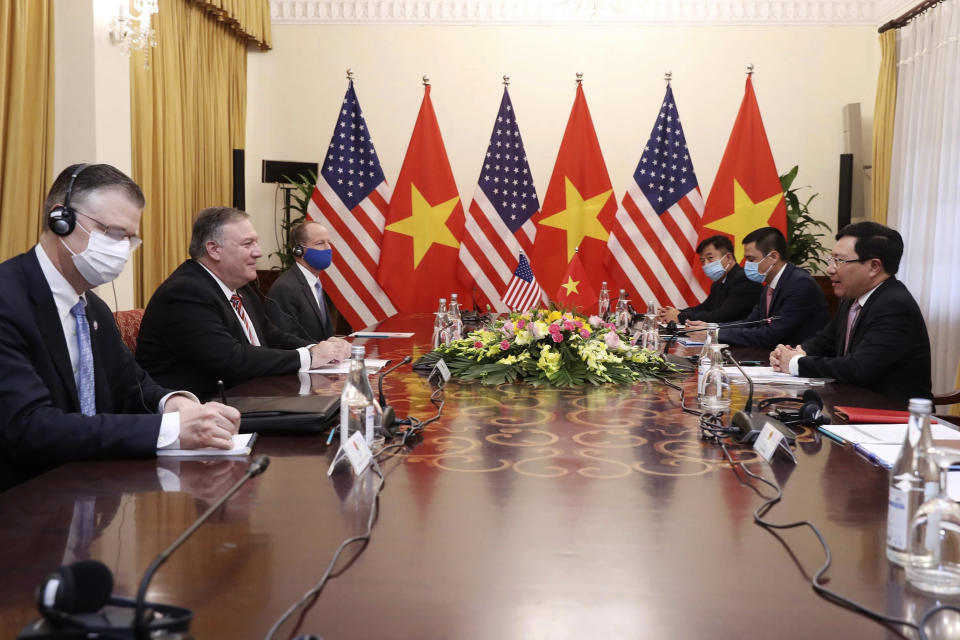 U.S. Secretary of State Mike Pompeo, second from left, and Vietnamese Foreign Minister Pham Binh Minh, right, attend a meeting in Hanoi, Vietnam, Friday, Oct. 30, 2020. Pompeo is wrapping up an anti-China tour of Asia in Vietnam as the fierce American presidential election race enters its final stretch. (Bui Lam Khanh/VNA via AP)