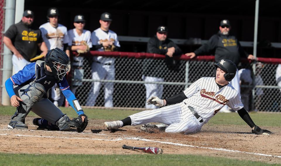 South Kitsap's Carson Puryear (4) slides into home ahead of the tag by the Graham-Kapowsin catcher on Tuesday, April 4, 2023.