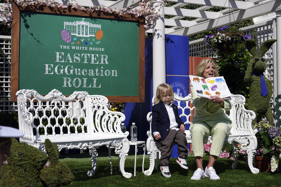 First lady Jill Biden sits with her grandson Beau Biden as she reads "Brown Bear, Brown Bear, What Do You See?" to children in the Jacqueline Kennedy Garden on Monday, April 10, 2023, during the annual White House Easter Egg Roll at the White House in Washington. (AP Photo/Susan Walsh)