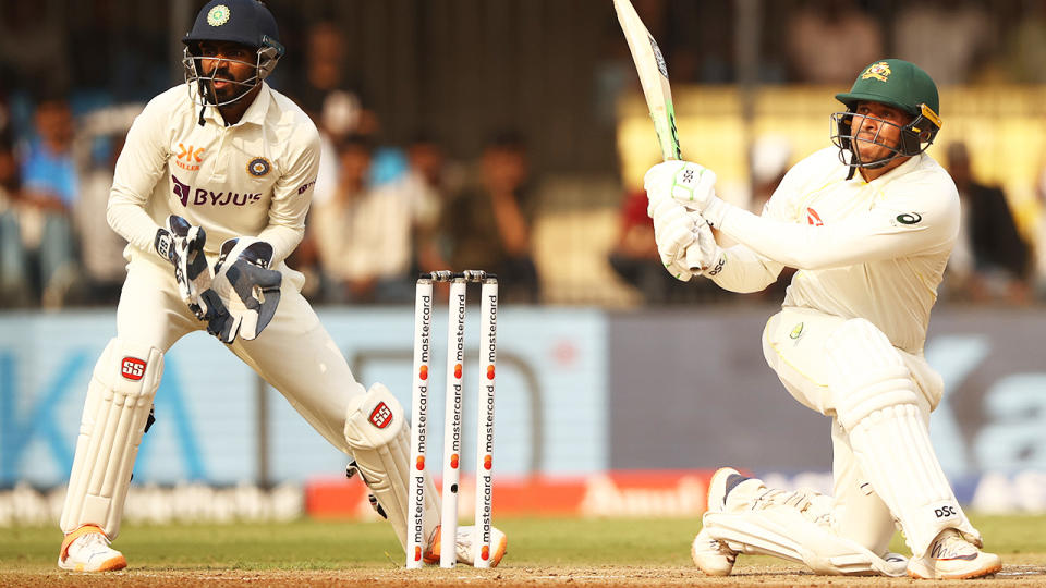 Usman Khawaja plays a sweep shot against India.