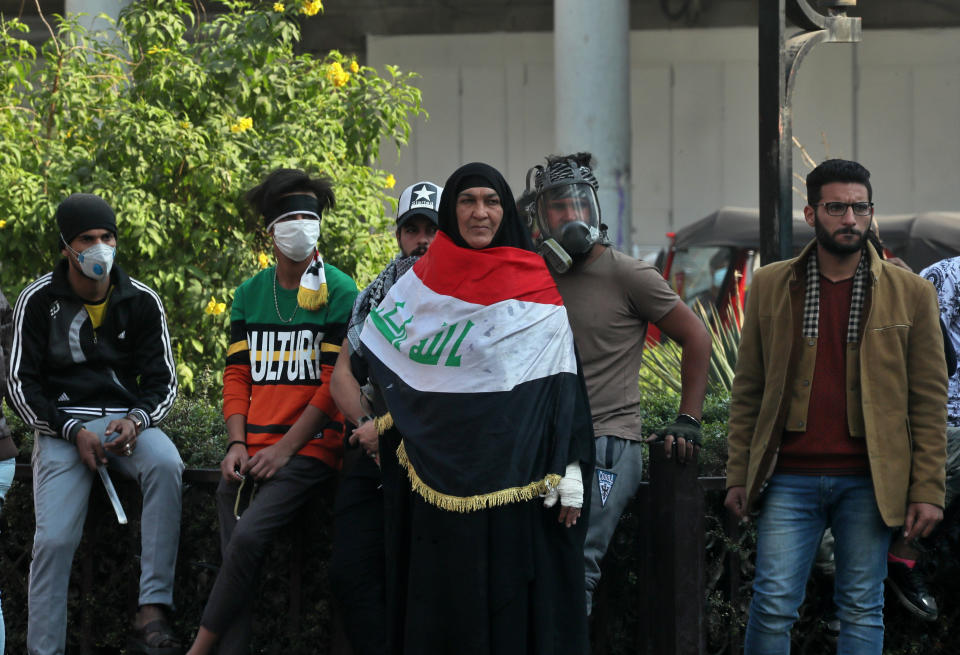 Anti-government protesters gather during clashes with security forces on Rasheed Street in Baghdad, Iraq, Tuesday, Nov. 26, 2019. (AP Photo/Hadi Mizban)