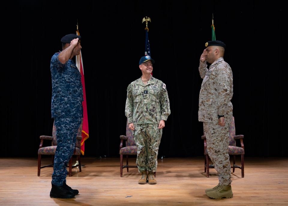 Vice Adm. Brad Cooper, commander of U.S. Naval Forces Central Command, U.S. 5th Fleet and Combined Maritime Forces, center; observes Royal Bahrain Naval Force Capt. Mohamed Almeer, left; and Royal Saudi Navy Capt. Assem Alamri, new commander of Combined Task Force 152; salute during a change of command ceremony in Manama, Bahrain, Aug. 27, 2023. (Photo by Mass Communication Specialist 2nd Class Naomi Johnson)