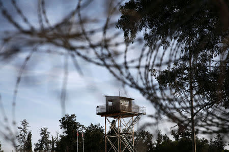 An abandoned UN outpost is seen behind the barbed wire inside the UN-controlled buffer zone in Nicosia, Cyprus November 11, 2016. REUTERS/Yiannis Kourtoglou