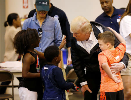 U.S. President Donald Trump and first lady Melania Trump visit with flood survivors of Hurricane Harvey at a relief center in Houston, Texas, U.S., September 2, 2017. REUTERS/Kevin Lamarque