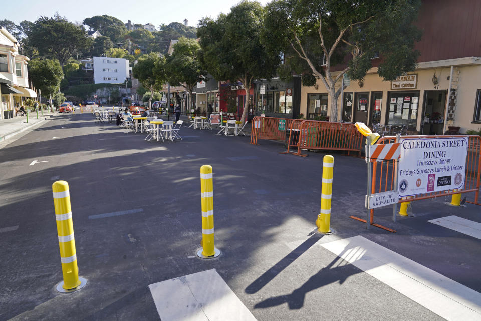 A street blocked off for outdoor dining is mostly empty Friday, Dec. 4, 2020, in Sausalito, Calif. The health officers in six San Francisco Bay Area regions have issued a new stay-at-home order as the number of virus cases surge and hospitals fill. The changes announced Friday will take effect in most of the area at 10 p.m. Sunday and last through Jan. 4. It means restaurants will have to close to indoor and outdoor dining, bars and wineries must close along with hair and nail salons and playgrounds. (AP Photo/Eric Risberg)