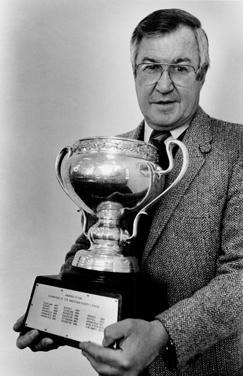 Joe Crozier holds the Calder Cup after returning to coach the Rochester Americans in October 1983. Crozier coached the Amerks to three Calder Cup titles in the 1960s.