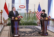 In this photo released by Indonesian Ministry of Foreign Affairs, U.S. Secretary of State Mike Pompeo, left, talks to Indonesian Foreign Minister Retno Marsudi during a joint press conference which was broadcasted online in Jakarta, Indonesia, Thursday, Oct. 29, 2020. Pompeo renewed the Trump administration's rhetorical onslaught against China in Indonesia on Thursday as the American presidential election looms. (Indonesian Ministry of Foreign Affairs via AP)