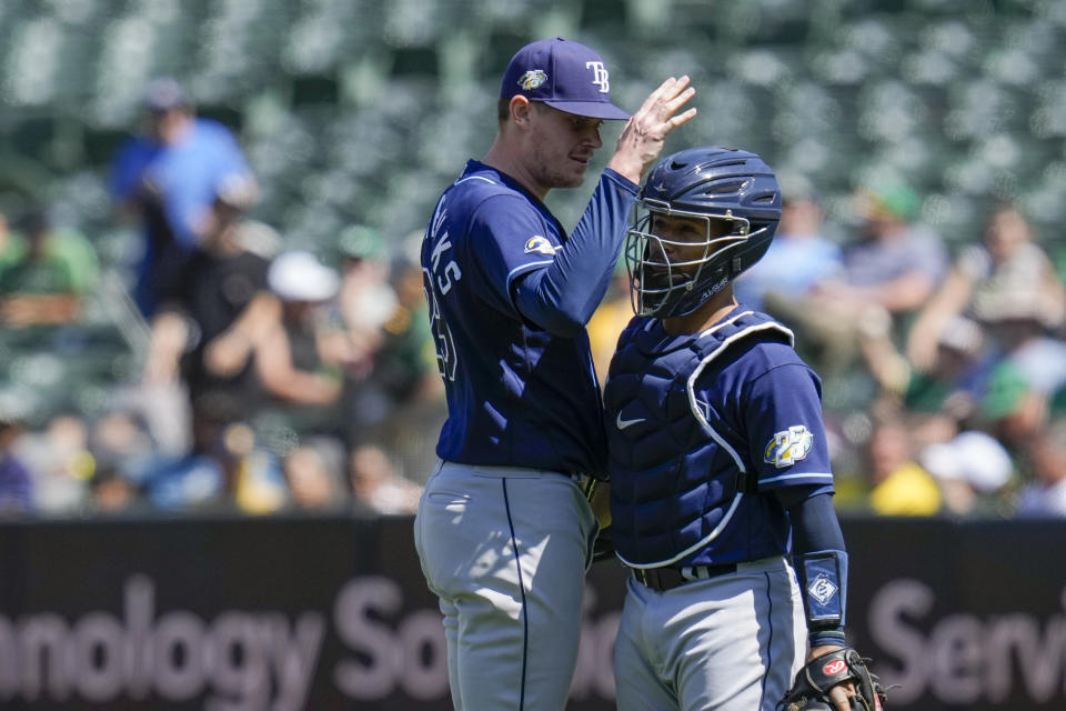 Tampa Bay Rays pitcher Pete Fairbanks, left, and catcher Francisco Mejía celebrate after their victory over the Oakland Athletics in a baseball game in Oakland, Calif., Thursday, June 15, 2023. (AP Photo/Godofredo A. Vásquez)