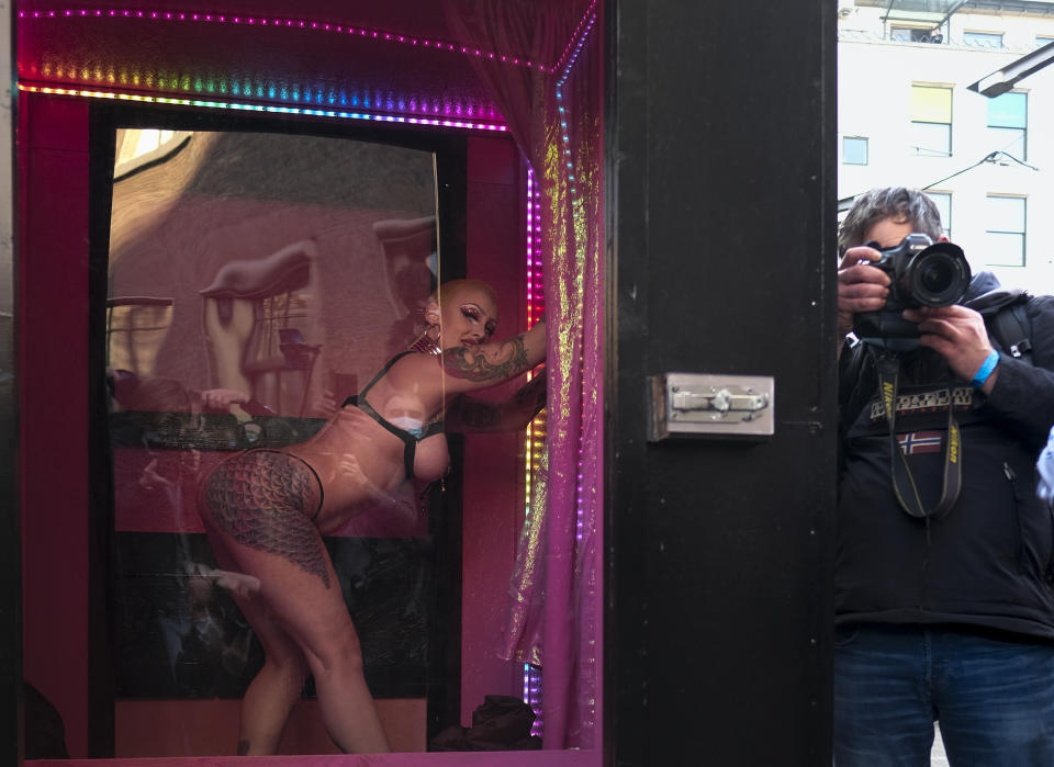 Sex workers protest unequal treatment and stigmatizing during a demonstration in The Hague, Netherlands, Tuesday, March 2, 2021. Stores in one village opened briefly, cafe owners across the Netherlands were putting tables and chairs on their outdoor terraces and sex workers demonstrated outside parliament in protests against the government's tough coronavirus lockdown. (AP Photo/Patrick Post)