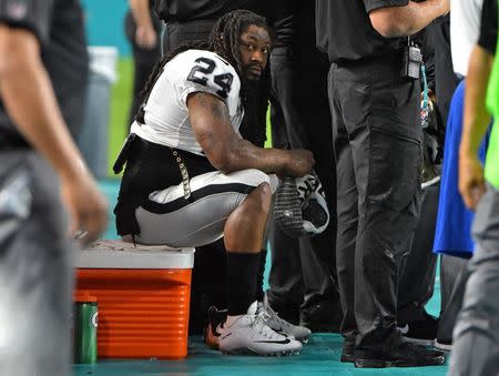 Nov 5, 2017; Miami Gardens, FL, USA; Oakland Raiders running back Marshawn Lynch (24) sits on a cooler during the National Anthem prior to the game against the Miami Dolphins at Hard Rock Stadium. Mandatory Credit: Jasen Vinlove-USA TODAY Sports