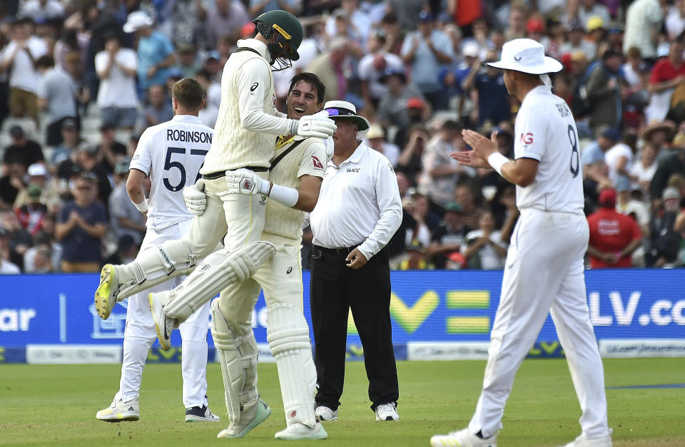 Australia captain Pat Cummins, right, celebrates with Australia's Nathan Lyon after beating England during day five of the first Ashes Test cricket match, at Edgbaston, Birmingham, England, Tuesday, June 20 2023. (AP Photo/Rui Vieira)