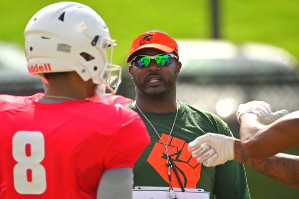 Florida A&M University head coach Willie Simmons talks to quarterback Jeremy Moussa (8) during fall training camp, Aug. 10, 2022