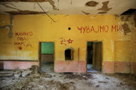 <p>Communist-era signs are seen on a wall inside an abandoned local community house in the village of Aldinac, near the southeastern town of Knjazevac, Serbia, Aug. 15, 2017. They read, from left: “Long live this nation” and “Keep the peace.” (R). (Photo: Marko Djurica/Reuters) </p>