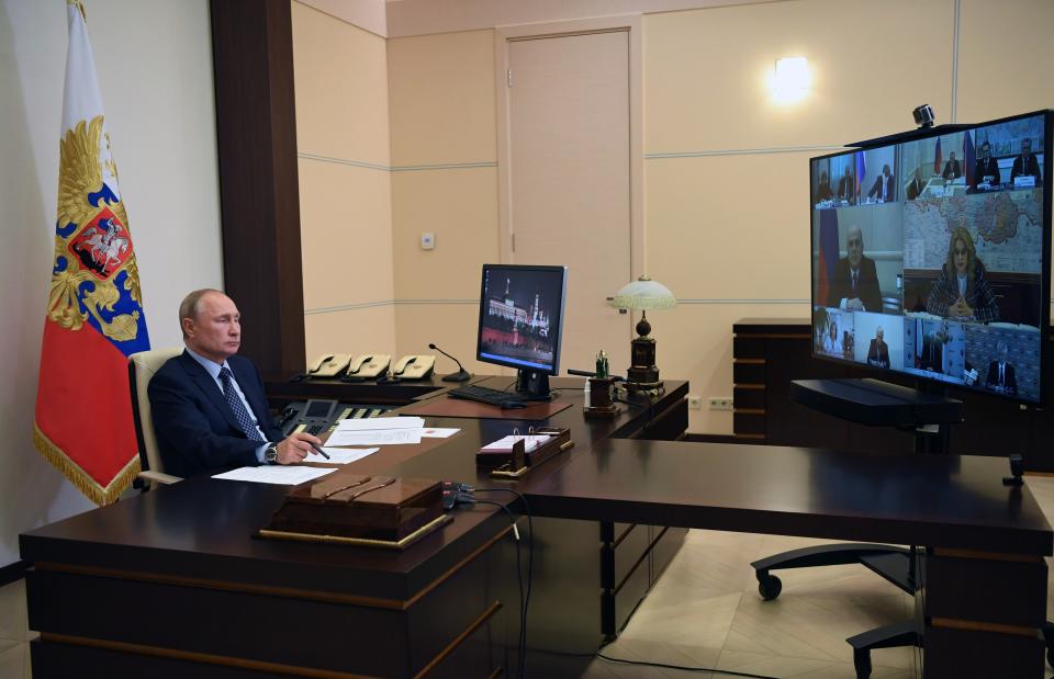 Russian President Vladimir Putin attends a cabinet meeting via teleconference at the Novo-Ogaryovo residence outside Moscow Moscow, Russia, Friday, May 22, 2020. Putin, speaking during Friday's video conference with top officials, "the positive dynamic is not so fast as we would like it to be, sometimes even unstable, but it does exist." (Alexei Nikolsky, Sputnik, Kremlin Pool Photo via AP)