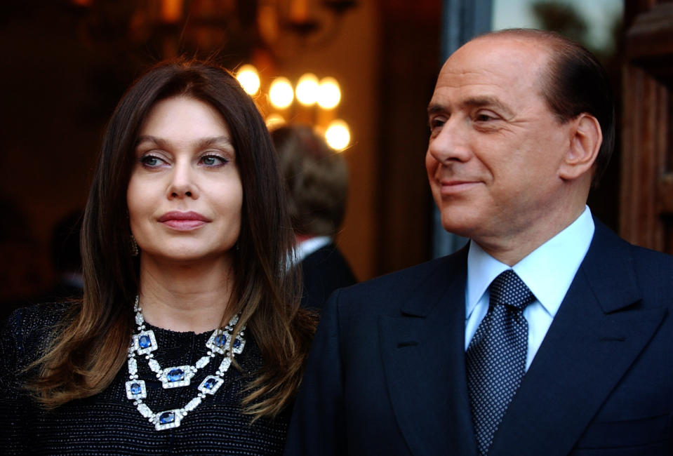 FILE - Italian premier Silvio Berlusconi, right, and his wife Veronica Lario wait for President George W. Bush and first lady Laura Bush at the Villa Madama residence for a social dinner, in Rome June 24, 2004. Berlusconi, the boastful billionaire media mogul who was Italy's longest-serving premier despite scandals over his sex-fueled parties and allegations of corruption, died, according to Italian media. He was 86. (AP Photo/Susan Walsh, File)