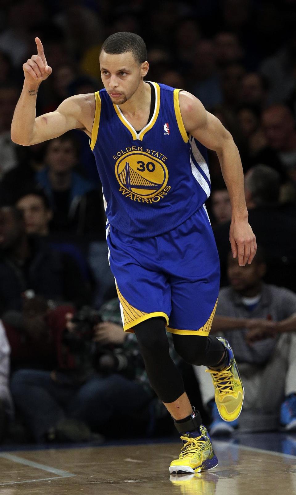 Golden State Warriors' Stephen Curry (30) gestures after scoring a 3-point basket during the first half of an NBA basketball game against the New York Knicks, Friday, Feb. 28, 2014, in New York. (AP Photo/Frank Franklin II)