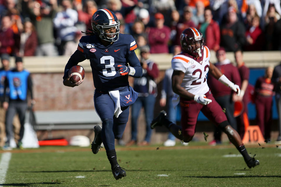 CHARLOTTESVILLE, VA - NOVEMBER 29: Bryce Perkins #3 of the Virginia Cavaliers rushes for a touchdown in the first half during a game against the Virginia Tech Hokies at Scott Stadium on November 29, 2019 in Charlottesville, Virginia. (Photo by Ryan M. Kelly/Getty Images)