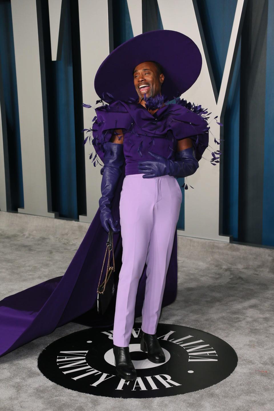 Billy Porter at the 2020 Oscars' Vanity Fair party wearing a purple gown and large hat