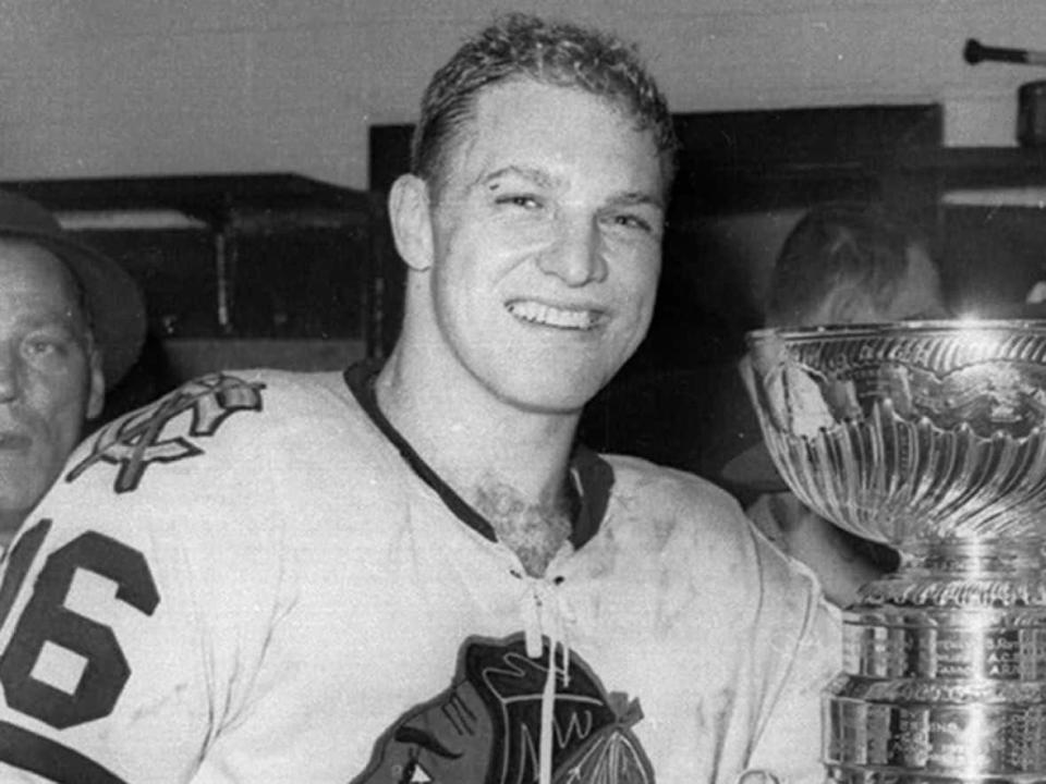 Bobby Hull, shown in the Chicago dressing room with the Stanley Cup after defeating the Red Wings for the 1961 NHL championship, died on Monday. (The Associated Press - image credit)