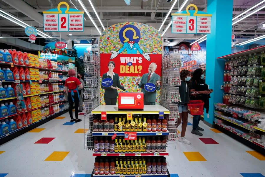 People walk through Omega Mart, an immersive art installation by arts production company Meow Wolf, Thursday, Feb. 18, 2021, in Las Vegas. The installation is located at Area15, a retail and entertainment complex in Las Vegas. (AP Photo/John Locher)