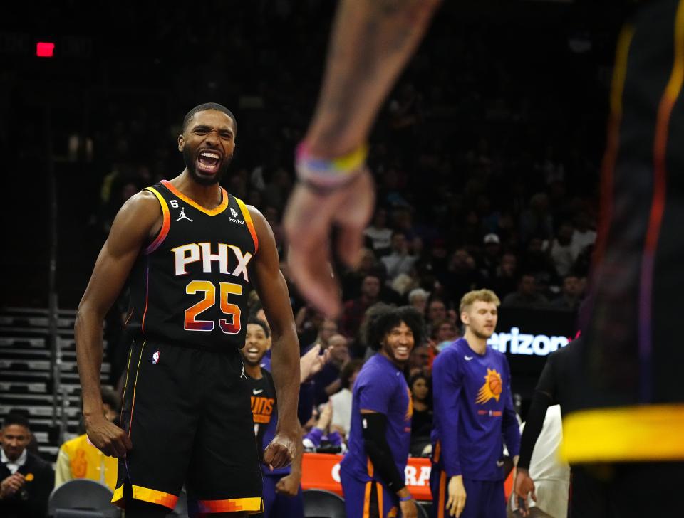 November 25, 2022; Phoenix, Ariz; USA; Suns wing Mikal Bridges (25) celebrates with Duane Washington Jr. (4) after a charge call against the Pistons during a game at the Footprint Center.