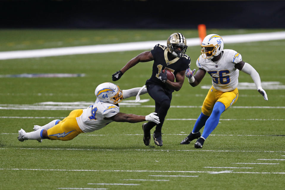 New Orleans Saints wide receiver Emmanuel Sanders (17) carries on a reception between Los Angeles Chargers outside linebacker Kyzir White (44) and linebacker Kenneth Murray (56) in the second half of an NFL football game in New Orleans, Monday, Oct. 12, 2020. (AP Photo/Brett Duke)