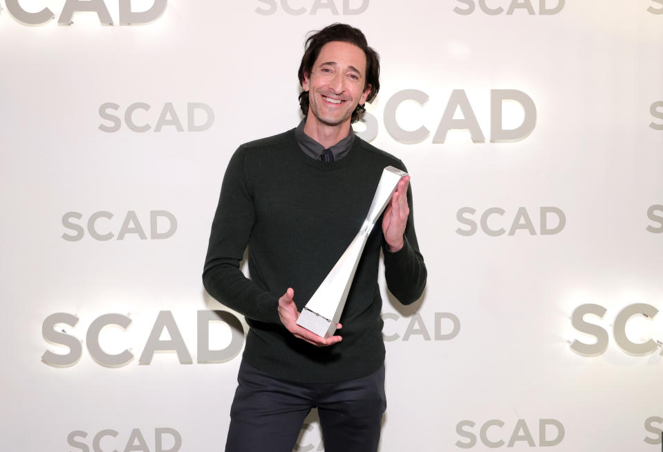 Brody holds an award