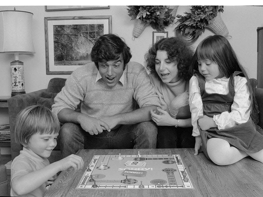 A family plays the board game Sorry