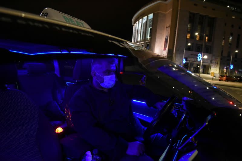 Greek driver Konstantinos Bekios is seen in his taxi that he turned into a 'night club' in Thessaloniki