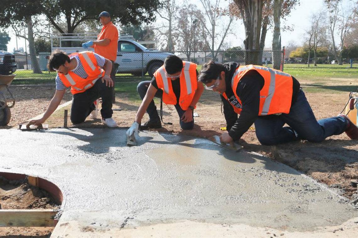 Students in the DInuba High School Construction Management Academy work on a sidewalk as they learn about the construction trade. The program was awarded a gold standard by Linked Learning Alliance.