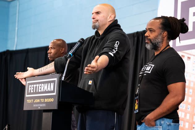 Fetterman appears on stage with Lee Horton (right) and his brother Dennis during a rally in Philadelphia in late September. Fetterman helped commute their prison sentences and went on to hire them as organizers.