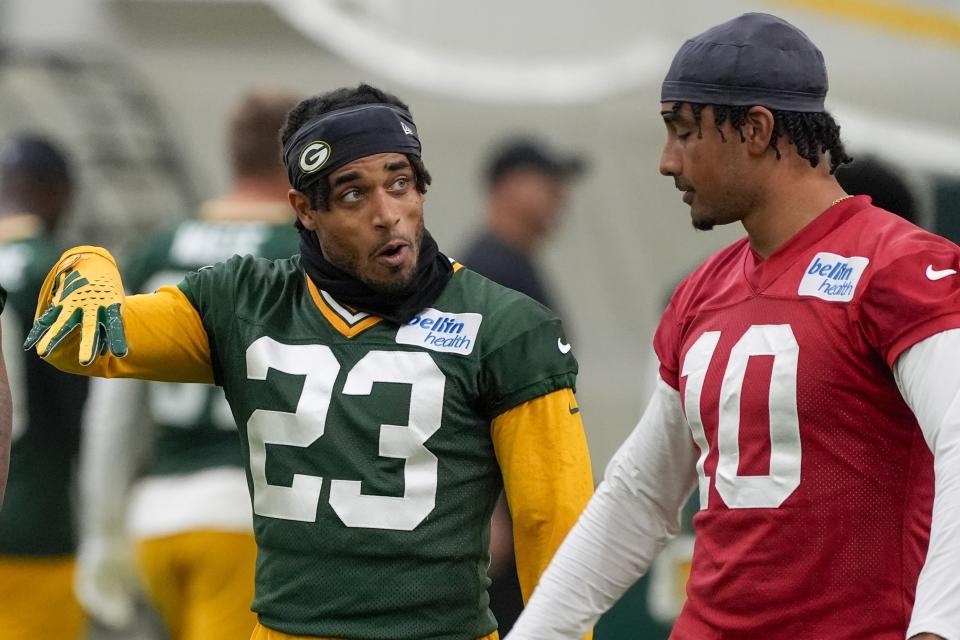 Green Bay Packers' Jaire Alexander talkls to Jordan Love during an NFL football practice Tuesday, May 21, 2024, in Green Bay, Wis. (AP Photo/Morry Gash)