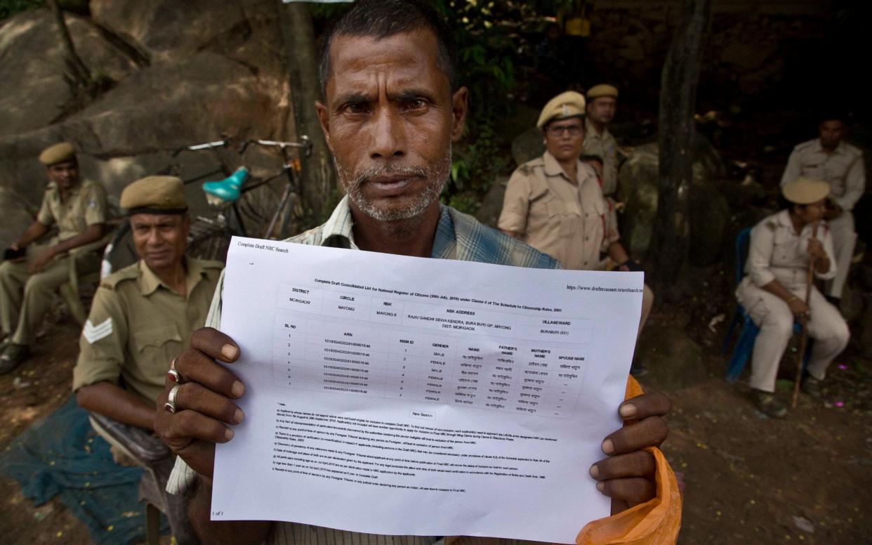 Muhammed Mainuddin shows his name on a sheet collected from the National Register of Citizens draft center in Mayoung as India released a list of its citizens in Assam - AP