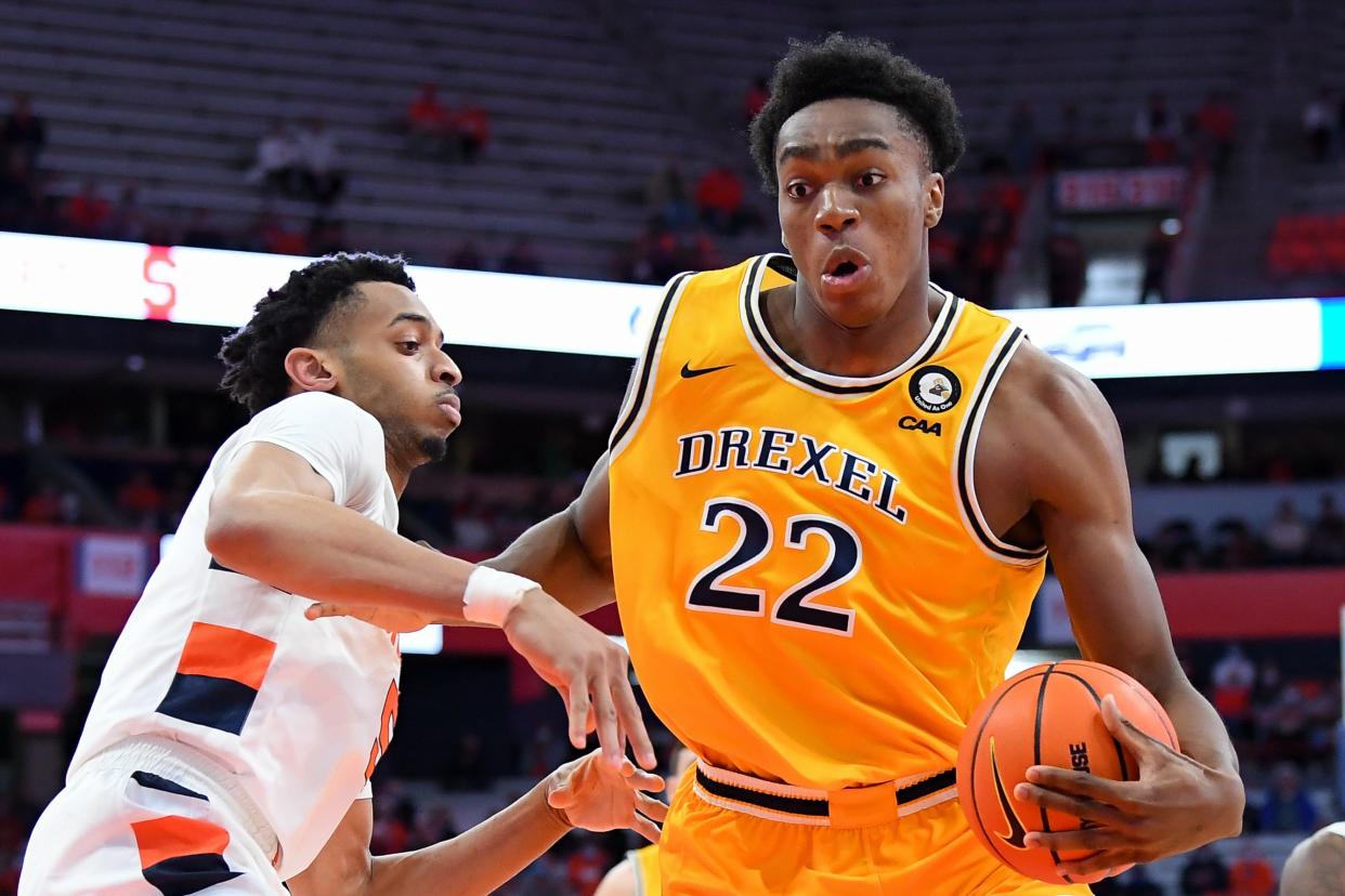 Nov 14, 2021; Syracuse, New York, USA; Drexel Dragons forward Amari Williams (22) drives to the basket against the defense of Syracuse Orange center Frank Anselem (left) during the first half at the Carrier Dome
