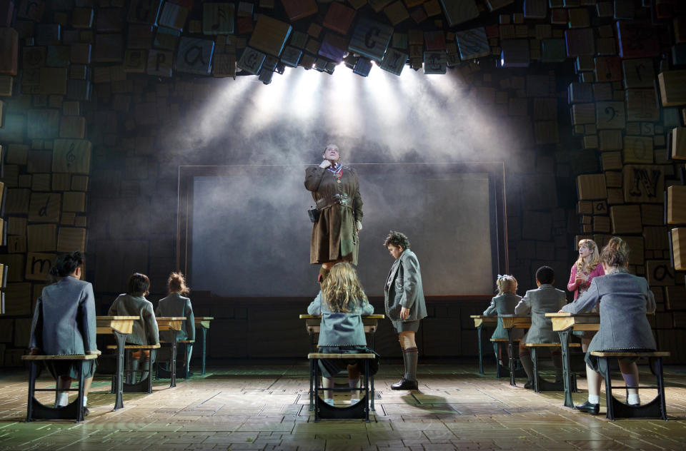 This theater publicity image released by Boneau/Bryan-Brown shows the cast of "Matilda The Musical," including Bertie Carvel, standing center, during a performance in New York. (AP Photo/Boneau/Bryan-Brown, Joan Marcus)