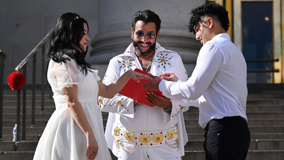 Osama Zayed puts a ring on his new wife Ingrid during the 16th Annual Burning Love Marriage Marathon on the steps of the City and County Building in Denver, Colorado on February 14, 2024. - Helen H. Richardson/MediaNews Group/The Denver Post/Getty Images