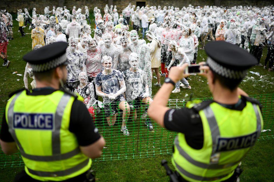 <p>Students from St Andrews University indulge in a tradition of covering themselves with foam to honor the “academic family” on Lower College Lawn on Oct. 23, 2017, in St Andrews, Scotland. (Photo: Jeff J Mitchell/Getty Images) </p>