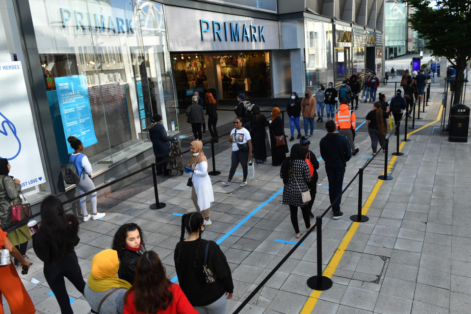 Shoppers in line wait for the opening of Primark in Birmingham.